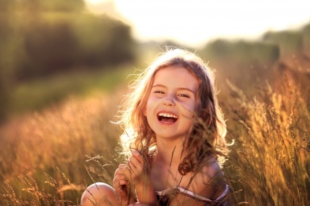 child laughing in the sunshine
