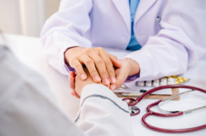 Doctor holding patient's hand