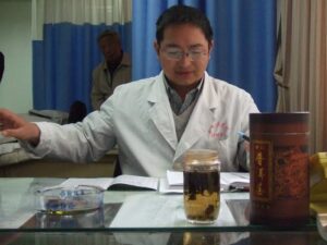 Doctor at desk in TCM Hospital, Kunming, China
